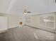 Spacious bedroom featuring neutral walls, plush carpet, and abundant natural light from the large double windows at 670 Sherwood Pl, Mooresville, NC 28115