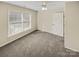 Neutral carpeted bedroom, offering natural light from a large window and standard door at 670 Sherwood Pl, Mooresville, NC 28115