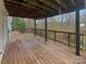 Spacious covered deck providing ample outdoor living space with tree views at 670 Sherwood Pl, Mooresville, NC 28115