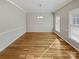 Spacious dining room featuring hardwood floors, chair rail and modern lighting at 670 Sherwood Pl, Mooresville, NC 28115