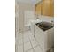Efficient laundry area with tile floor, modern washer and dryer, and window at 670 Sherwood Pl, Mooresville, NC 28115