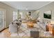 Staged living room with modern decor, hardwood floors, and plenty of natural light at 670 Sherwood Pl, Mooresville, NC 28115