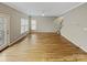 Spacious living room featuring hardwood floors, a ceiling fan, and a door to the deck at 670 Sherwood Pl, Mooresville, NC 28115