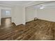 Bright open living room with wood floors, neutral paint, and ceiling fan at 670 Sherwood Pl, Mooresville, NC 28115