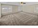 Large main bedroom with carpet, multiple windows, and ceiling fan at 670 Sherwood Pl, Mooresville, NC 28115