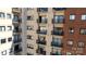 Exterior view of a condo building featuring private balconies for each unit, offering outdoor living spaces at 715 N Church St # 503, Charlotte, NC 28202