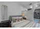 Cozy bedroom featuring a comfortable bed, stylish mirror, and neutral color palette at 715 N Church St # 503, Charlotte, NC 28202