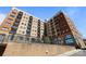 Low angle of a condo building exterior showing balconies, brick accents, and landscaped surroundings at 715 N Church St # 503, Charlotte, NC 28202
