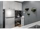 Contemporary kitchen equipped with stainless steel appliances, stylish black backsplash, and pendant lighting at 715 N Church St # 503, Charlotte, NC 28202
