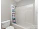 A bathroom featuring a bathtub and shower with shower curtain and white toilet at 7212 Hackberry Ln, Charlotte, NC 28226