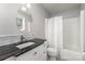 Bathroom featuring a single sink with black countertops and shower with curtain at 7212 Hackberry Ln, Charlotte, NC 28226