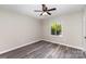An empty bedroom featuring wood-look flooring, a ceiling fan and a window at 7212 Hackberry Ln, Charlotte, NC 28226