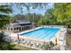 Large community pool surrounded by lounge chairs and lush greenery, perfect for relaxation at 7212 Hackberry Ln, Charlotte, NC 28226