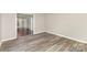 Dining room featuring wood-look flooring and a view of the hallway at 7212 Hackberry Ln, Charlotte, NC 28226