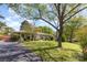 Charming ranch-style home with a spacious front yard and mature trees at 7212 Hackberry Ln, Charlotte, NC 28226