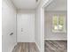 Bright foyer with neutral walls, wood-look flooring, and a large window at 7212 Hackberry Ln, Charlotte, NC 28226