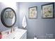Elegant half bathroom featuring a stylish mirror, vanity, towel and tasteful decor at 769 Seigle Point Dr, Charlotte, NC 28204