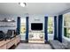 Bright living room showcasing a entertainment center, shelving, and comfortable seating with lots of natural light at 769 Seigle Point Dr, Charlotte, NC 28204