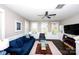 Bright living room featuring dark hardwood floors, large windows, and a comfortable blue sofa at 769 Seigle Point Dr, Charlotte, NC 28204