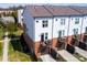 Modern townhome featuring a brick facade, cozy balcony, and attached garage at 769 Seigle Point Dr, Charlotte, NC 28204