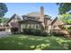Expansive backyard with lush green lawn, mature trees, and a deck, perfect for outdoor enjoyment at 8011 Greencastle Dr, Charlotte, NC 28210