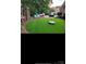 Artificial turf backyard with pergola, seating, trampoline, and manicured landscaping at 8011 Greencastle Dr, Charlotte, NC 28210