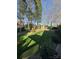 Landscaped backyard featuring artificial turf and a charming wooden pergola at 8011 Greencastle Dr, Charlotte, NC 28210
