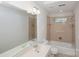 Well lit bathroom with a large vanity, large mirror, and tub and shower combo at 8011 Greencastle Dr, Charlotte, NC 28210