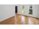 Bedroom features hardwood floors, natural light, and neutral paint scheme at 8011 Greencastle Dr, Charlotte, NC 28210