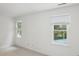 Bedroom with neutral carpet, white base trim, and natural light from the double windows at 8011 Greencastle Dr, Charlotte, NC 28210