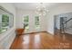 Dining room with hardwood floors, modern chandelier, and natural light from windows at 8011 Greencastle Dr, Charlotte, NC 28210