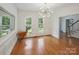 Bright dining area with hardwood floors, large windows, and modern lighting, ideal for entertaining at 8011 Greencastle Dr, Charlotte, NC 28210
