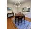 Formal dining room with modern lighting, wood floors, and ample space at 8011 Greencastle Dr, Charlotte, NC 28210
