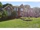 Charming two-story brick residence featuring lush green lawn and mature greenery at 8011 Greencastle Dr, Charlotte, NC 28210