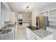 White kitchen featuring granite countertops, stainless steel appliances, and an island cooktop at 8011 Greencastle Dr, Charlotte, NC 28210