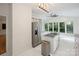 Bright kitchen features an island, stainless steel appliances, and a wall of windows at 8011 Greencastle Dr, Charlotte, NC 28210
