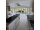 Bright kitchen with granite countertops and stainless appliances that opens up to the dining area at 8011 Greencastle Dr, Charlotte, NC 28210