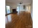 Empty living room features hardwood floors and a fireplace at 8011 Greencastle Dr, Charlotte, NC 28210