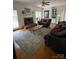 Spacious living room with fireplace, hardwood floors, and comfortable seating arrangement at 8011 Greencastle Dr, Charlotte, NC 28210