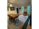 Cozy office space with natural light, hardwood floors, and a putting green for indoor practice at 8011 Greencastle Dr, Charlotte, NC 28210