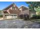 Brick house with a two-car garage, an expansive driveway, and lush landscaping at 8011 Greencastle Dr, Charlotte, NC 28210