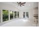 Bright sunroom with tiled floors, white cabinets, and natural light from large windows at 8011 Greencastle Dr, Charlotte, NC 28210