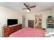 This bedroom offers great storage, a ceiling fan, and a view to the bathroom at 8175 Cedar Glen Dr, Charlotte, NC 28212