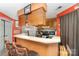 Cozy kitchen features wood cabinets, breakfast bar, and functional layout at 8175 Cedar Glen Dr, Charlotte, NC 28212