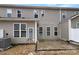 Backyard featuring a patio, gray siding, and sliding glass doors at 8212 Merryvale Ln, Charlotte, NC 28214