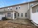 Backyard featuring a patio, gray siding, and sliding glass doors at 8212 Merryvale Ln, Charlotte, NC 28214