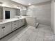 Elegant bathroom featuring a double vanity, and a walk-in shower with modern fixtures at 8212 Merryvale Ln, Charlotte, NC 28214