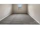 Neutral bedroom with gray carpet and window providing natural light at 8212 Merryvale Ln, Charlotte, NC 28214