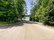 Scenic view of a private boat ramp leading to the lake, surrounded by lush trees at 8212 Merryvale Ln, Charlotte, NC 28214