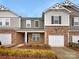 Charming townhome with a brick facade, attached garage, and manicured landscaping, offering great curb appeal at 8212 Merryvale Ln, Charlotte, NC 28214